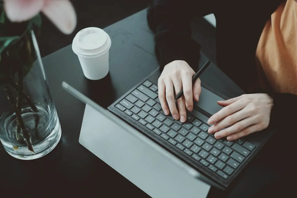 Woman Working on Laptop At a Café