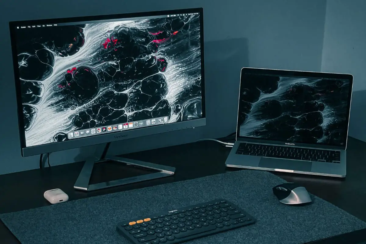 A PC and Laptop Setup on a Computer Table