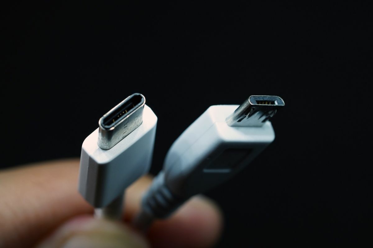 Hand Holding Micro USB and Type C USB Cable