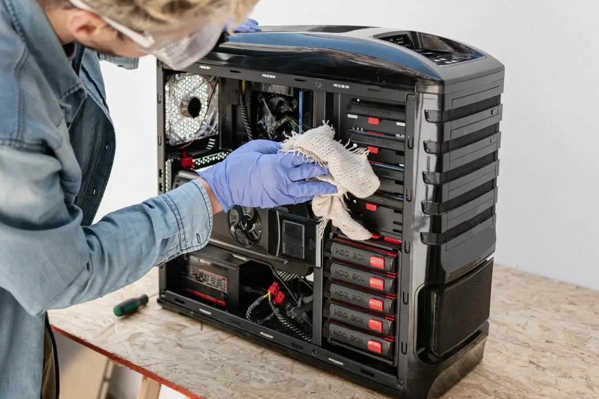 Man Cleaning PC Cabinet with Piece of Cloth