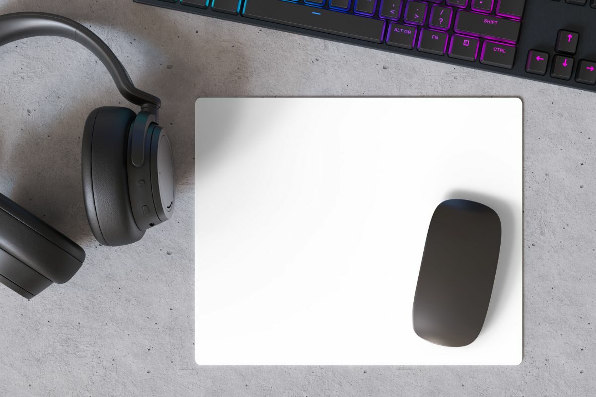 Mouse on a White Mousepad with Keyboard and Headset