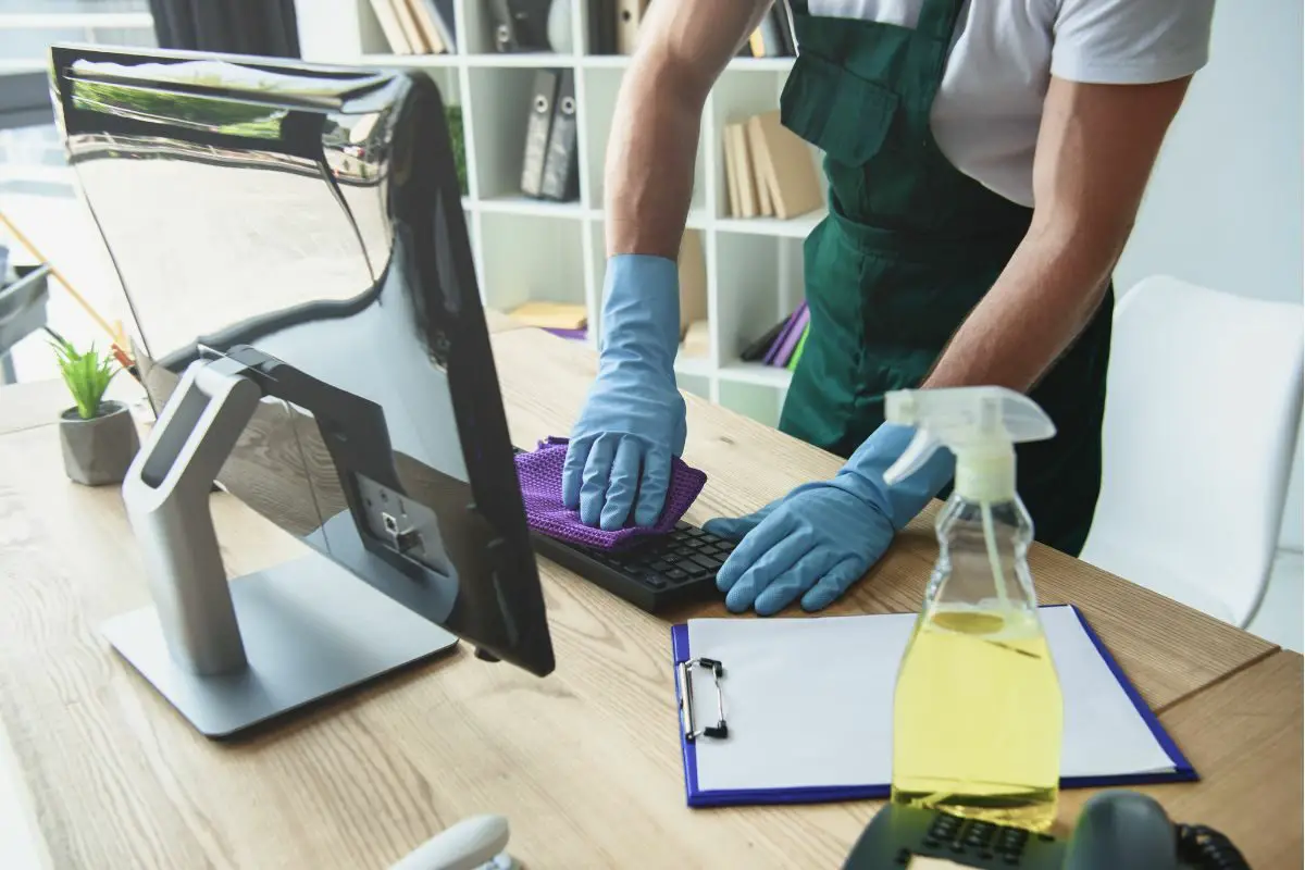 Professional Cleaner with the Gloves Cleaning Computer Keyboard