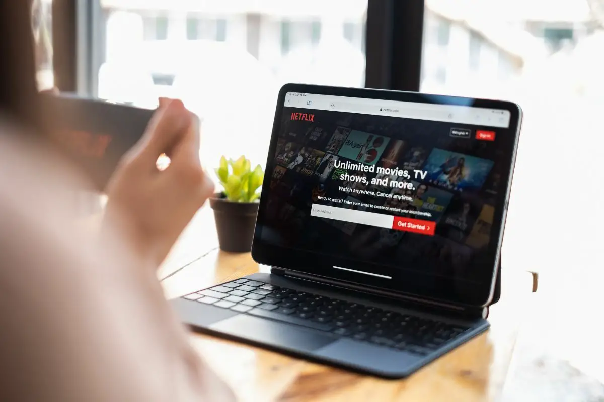 Woman Checking Netflix on a Laptop and Mobile