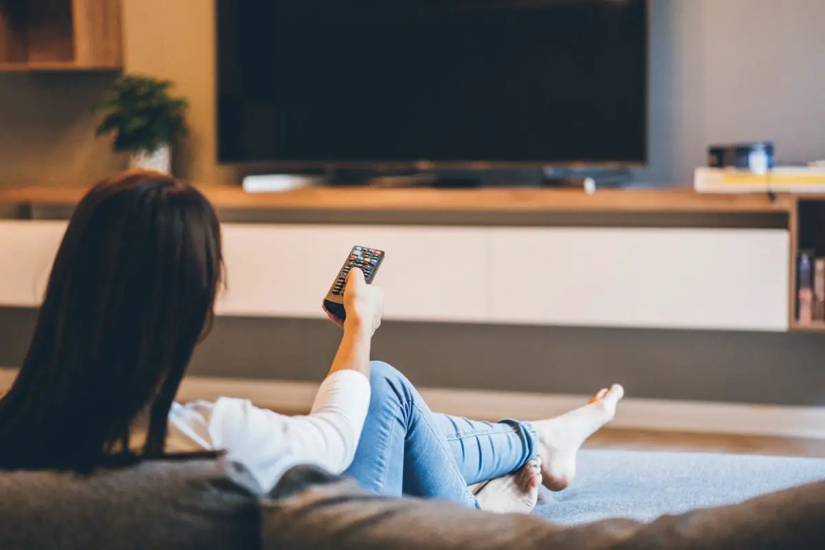 Woman Switching on the TV