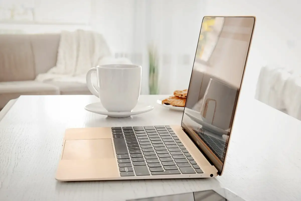 Modern Apple MacBook and Coffee Cup On the Table